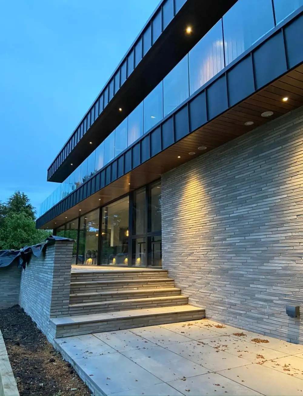 Modern East Midlands home with warm exterior lighting at dusk