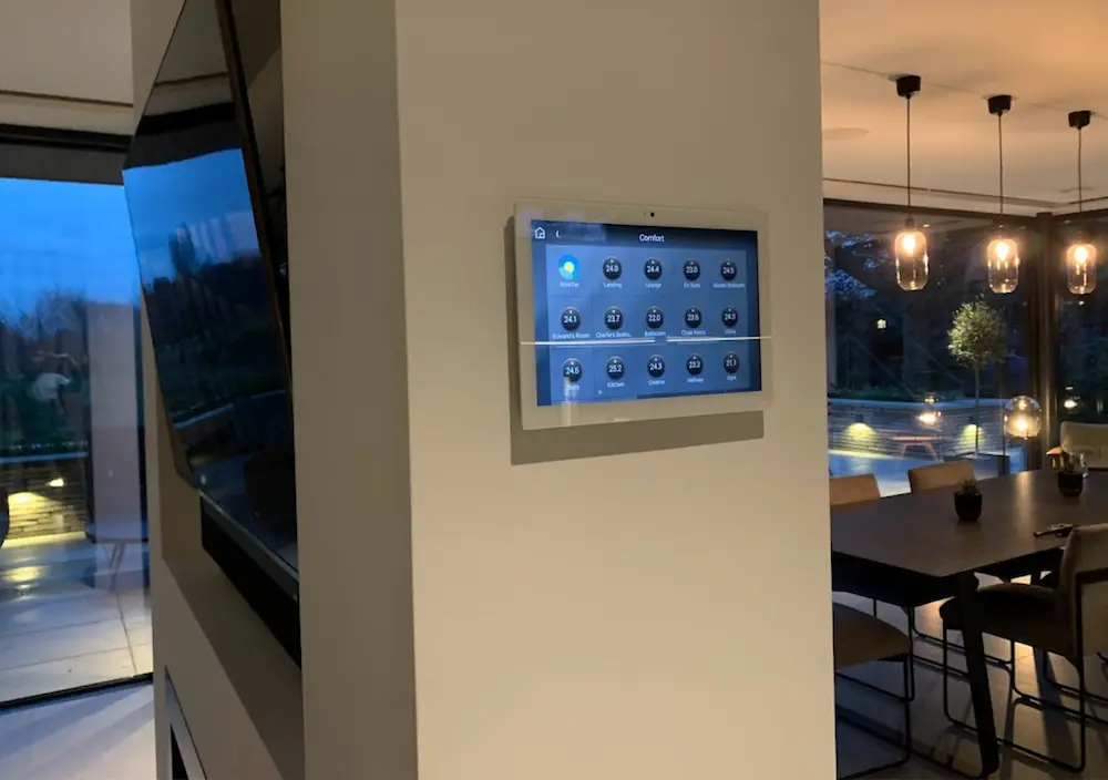 Wall-mounted smart heating control panel at dusk